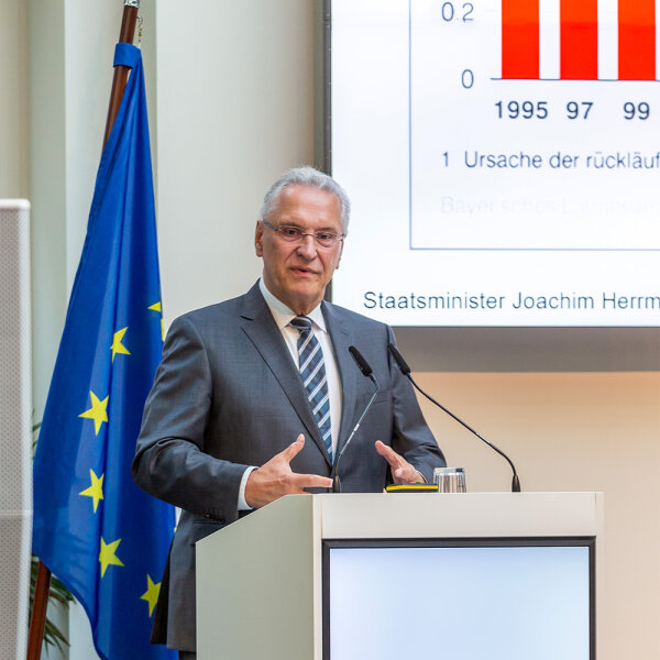 Innenminister Joachim Herrmann bei Präsentation hinter Rednerpult